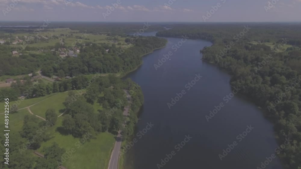 Long Lake and Wooden Bridge on a Sunny Summer Day. Aerial Flying Backwards Long Lake and Wooden Bridge on a Sunny Summer Day. Aerial Flying Backwards