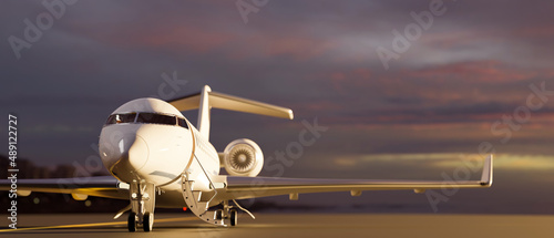 Obraz na płótnie A luxury private jet parked on runway over blurred sunset sky view