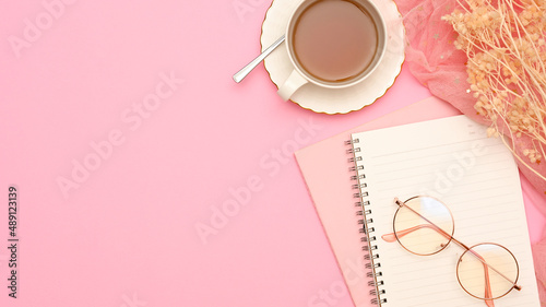 A minimal feminine workspace in pink table background