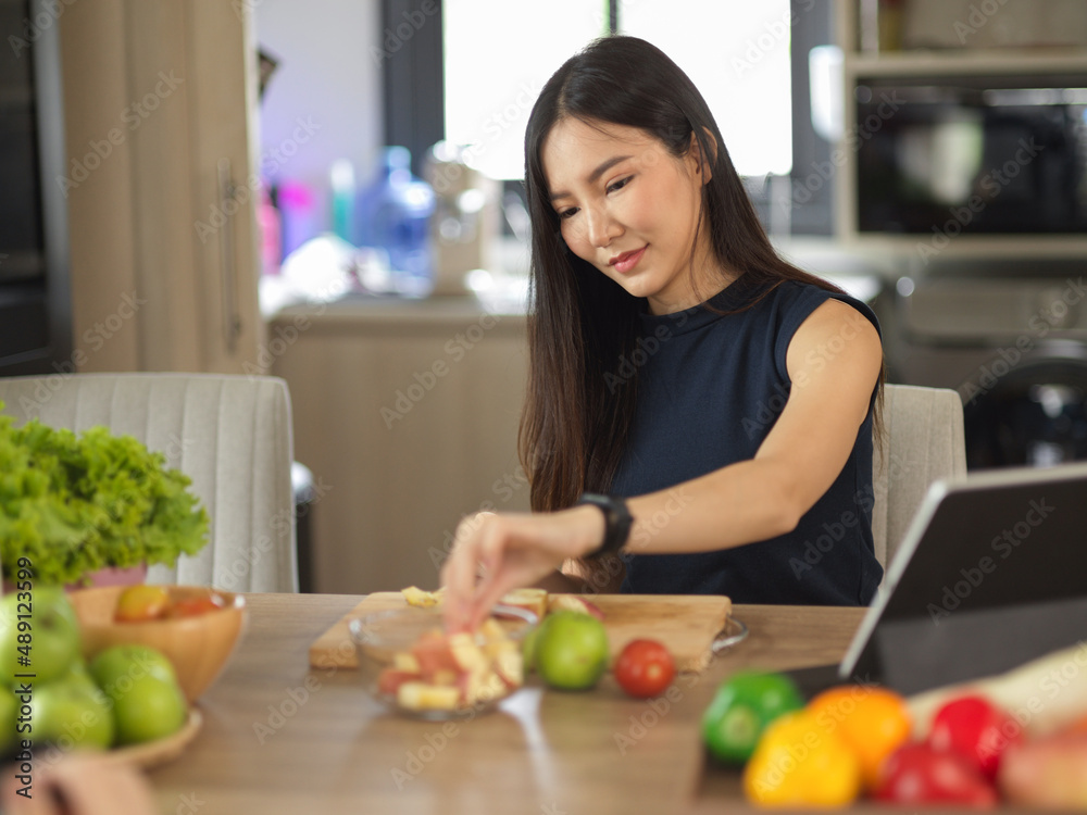 Woman preparing fruits and vegetables for her healthy drink Woman preparing fruits and vegetables for her healthy drink