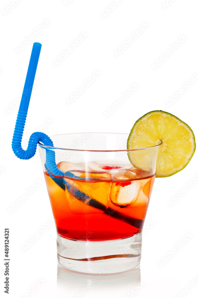 Summer cocktail in transparent glass with cherry, lime, and ice isolated on white background