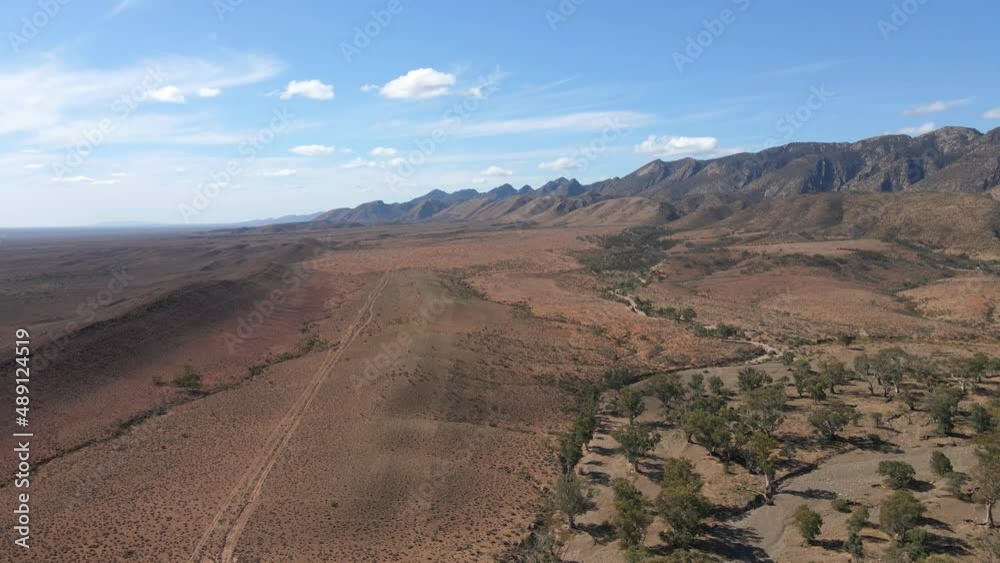 Brachina Gorge creek vegetation, Mountain range as background. Australian Outback, Descending view Brachina Gorge creek vegetation, Mountain range as background. Australian Outback, Descending view