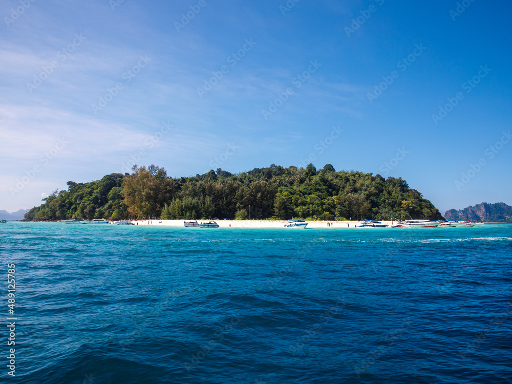 Beautiful view of Ko Phai or Bamboo Island with white sand beach, jungly forest and boats, Krabi Province, Thailand