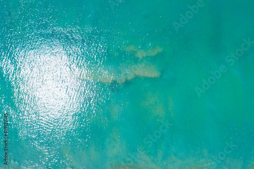 Sea surface aerial view,Bird eye view photo of small waves and water surface texture Turquoise sea background Beautiful nature Amazing view © panya99
