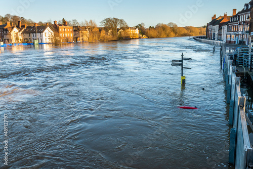 Critically high river waters flowing through Bewdly Bridge,protected by flood defence barriers,Bewdley,Worcestershire,England,UK.
