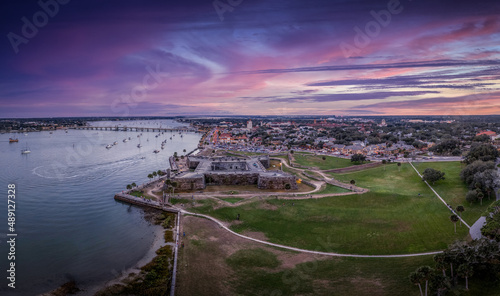 Stunning aerial sunset shot of St Augustine Florida, Castillo de San Marcos with four cannon bastions purple, blue, red sky