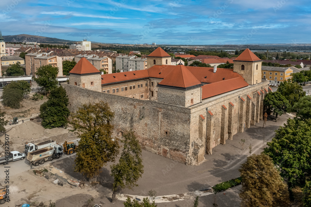 Aerial view of the back of Thury castle in Varpalota Hungary with four square towers restored palace building and buttresses supporting the castle wall