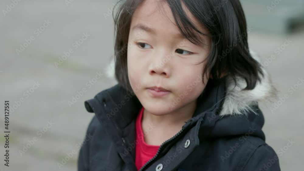 Close up shot of a happy Asian boy smiling in the park. Close up shot of a happy Asian boy smiling in the park.