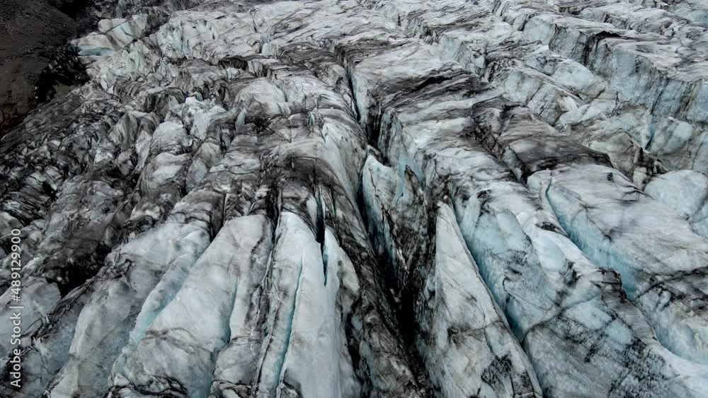 Beautiful Cinematic Aerial view of the massive Svinafellsjokull Glacier in Iceland and its lagoon caused by global warming Beautiful Cinematic Aerial view of the massive Svinafellsjokull Glacier in Iceland and its lagoon caused by global warming