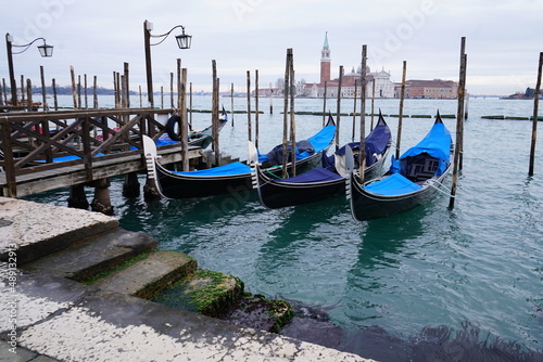 Gondolas docked at the harbour front in Venice