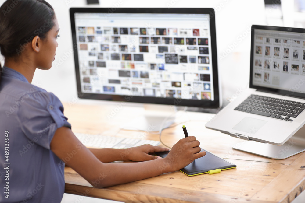 Using technology to get the job done. Cropped shot of an attractive young businesswoman using a wireless device. Using technology to get the job done. Cropped shot of an attractive young businesswoman using a wireless device.