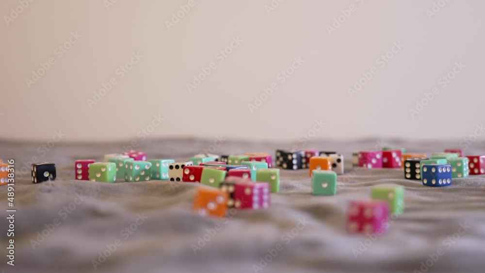 Rolling blue dice onto a pile in extreme slow motion. Rolling blue dice onto a pile in extreme slow motion.