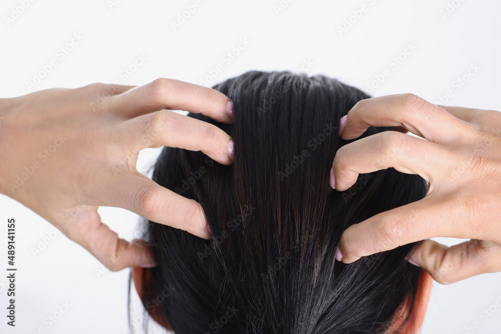 Close-up of female hands massaging her head Close-up of female hands massaging her head