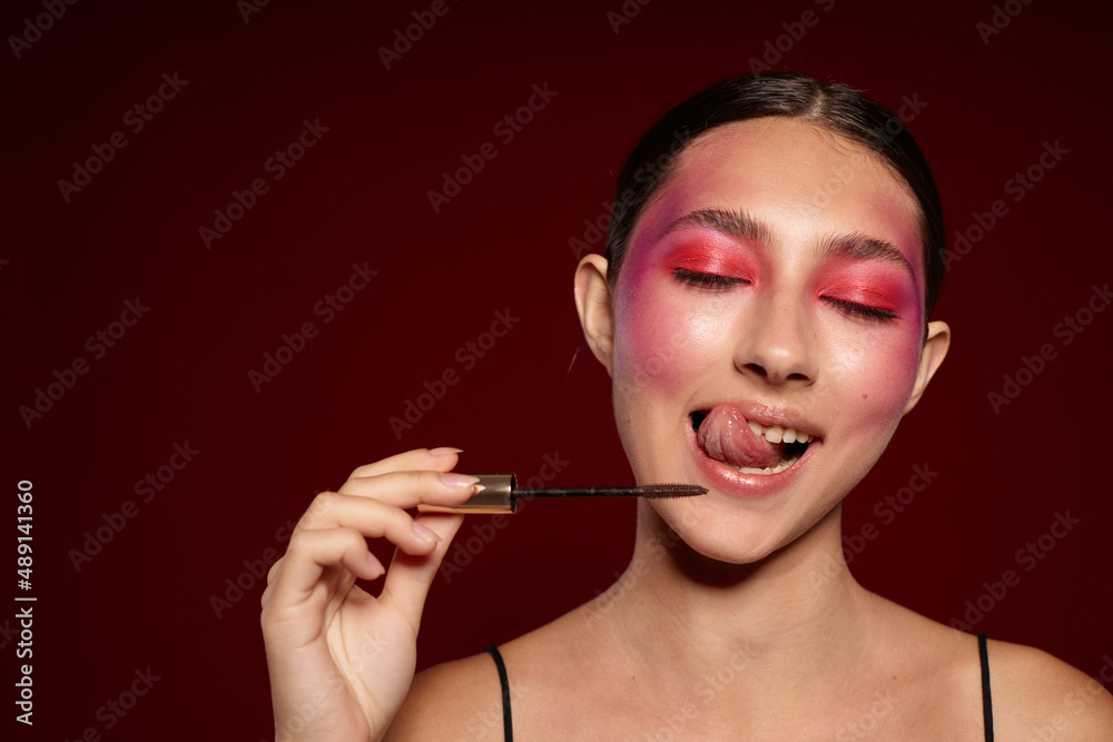 Young beautiful woman pink face makeup posing attractive look skin care cropped view unaltered Young beautiful woman pink face makeup posing attractive look skin care cropped view unaltered