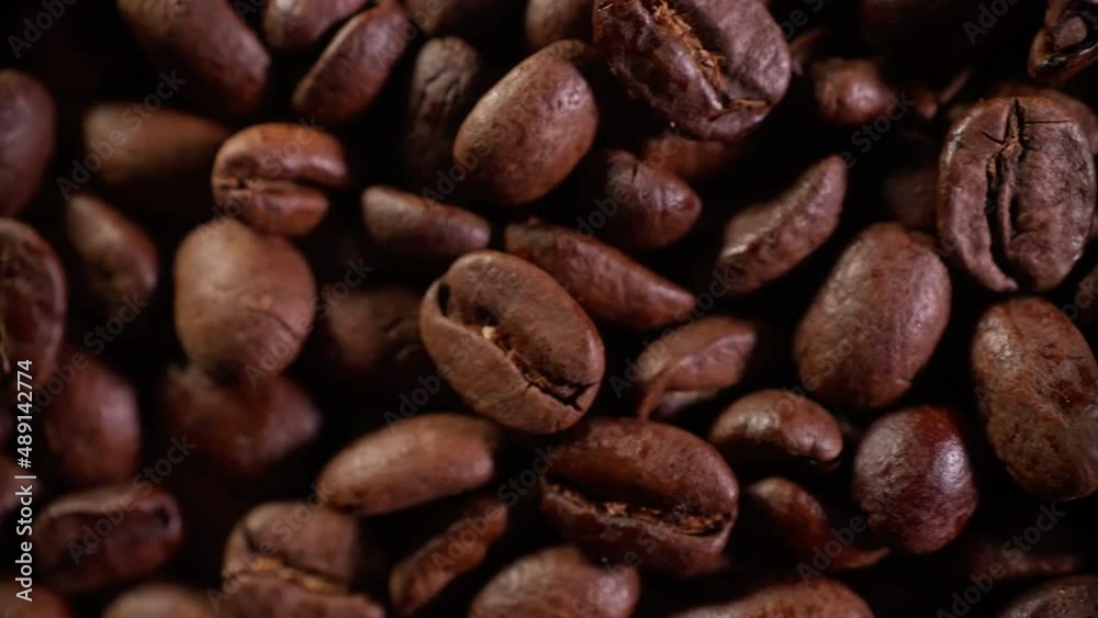 Coffee beans in the roasting process shot in close-up. smooth flight of the camera along the mass of coffee beans Coffee beans in the roasting process shot in close-up. smooth flight of the camera along the mass of coffee beans