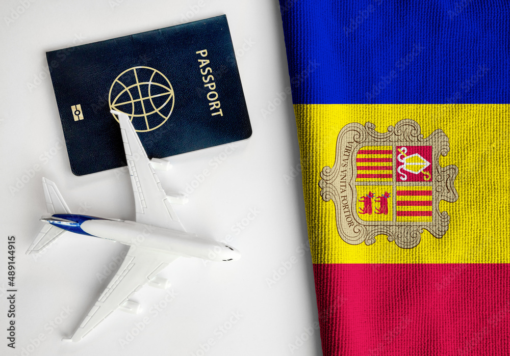 Obraz na płótnie Flag of Andorra with passport and toy airplane. Flight travel concept.
 w salonie