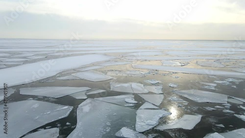 Establishing shot ocean surface completly frozen with ice formations photo