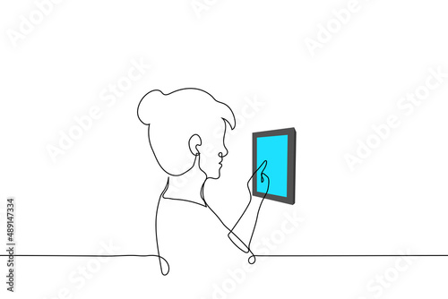 woman presses the touchpad on the wall inside the house - one line drawing vector. concept smart home system