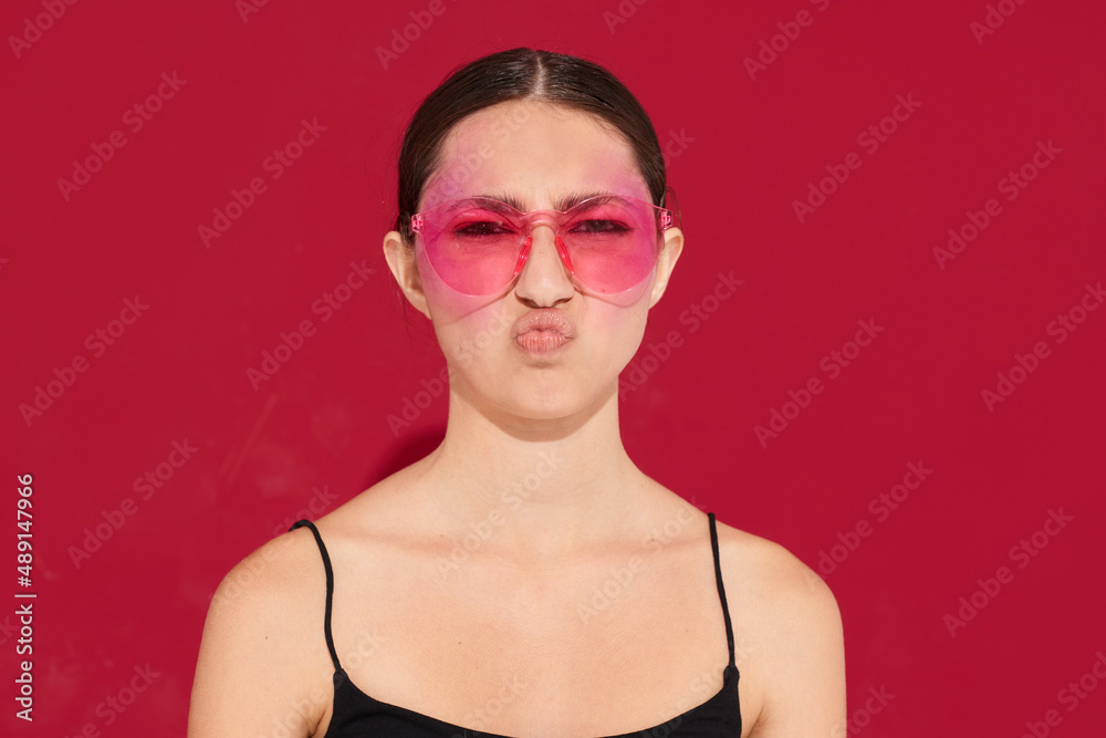 pretty woman pink glasses bright makeup posing black jersey pink background unaltered pretty woman pink glasses bright makeup posing black jersey pink background unaltered