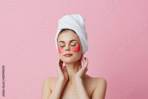 woman pink patches on the face with a towel on the head close-up Lifestyle