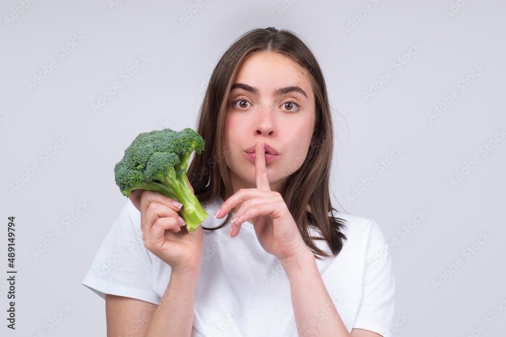 Fitness and healthy woman. Healthy food, health secret diet. Woman holding perfect product for dieting green broccoli. Isolated portrait. Fitness and healthy woman. Healthy food, health secret diet. Woman holding perfect product for dieting green broccoli. Isolated portrait.