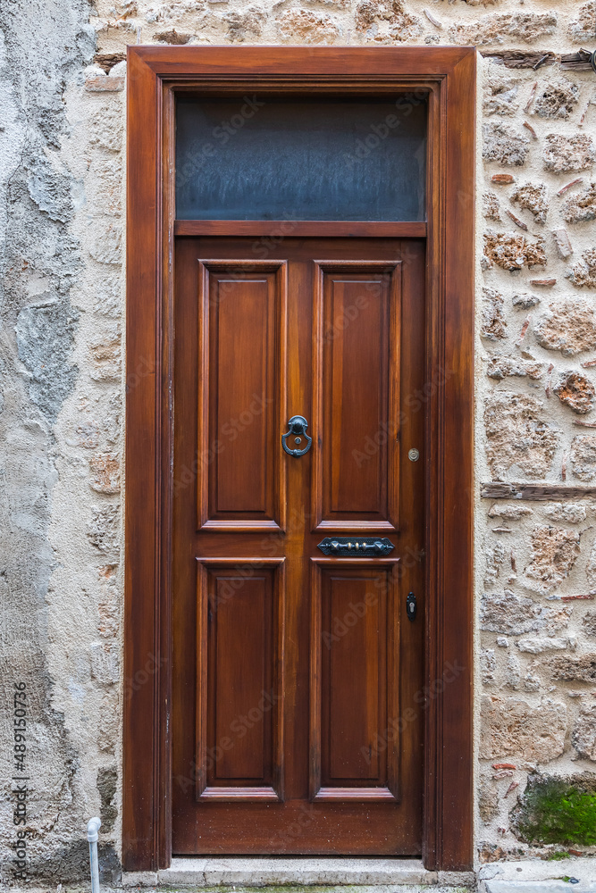 Close-up of a   brown wooden  door in an old stone mansion house