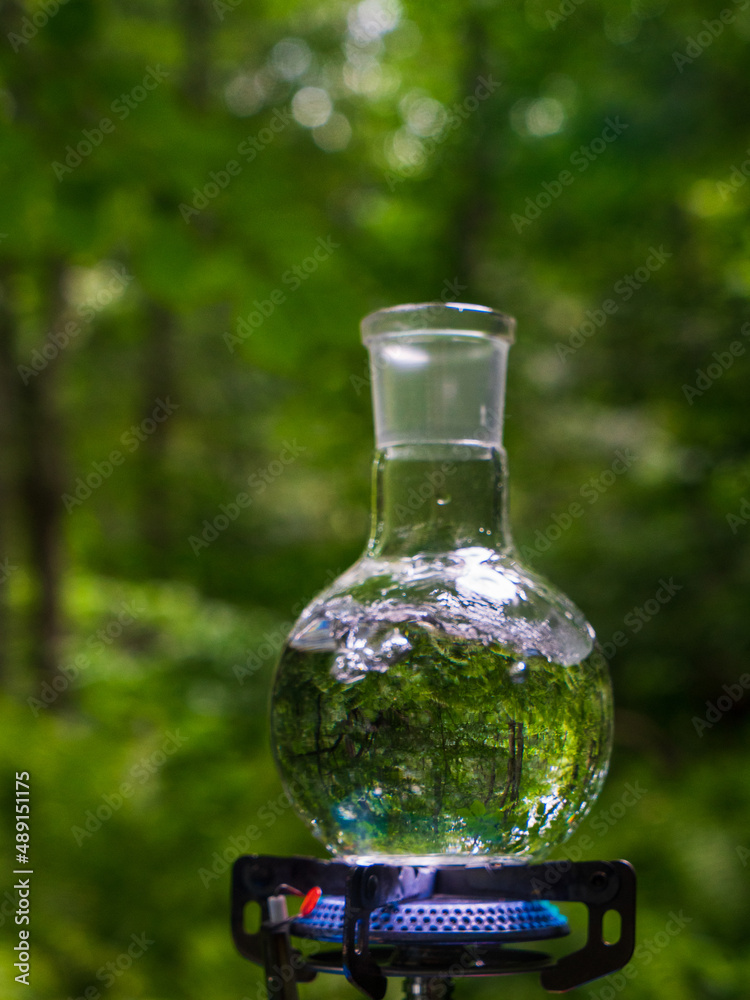 Glass flask with boiling water on a gas burner. Glass flask with boiling water on a gas burner.