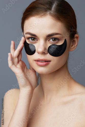 portrait woman face black patches posing isolated background