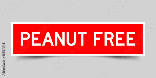 Inserted red color label sticker with word peanut free on gray background