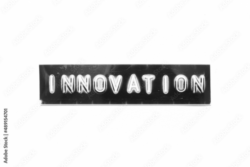 Embossed letter with word innovation in black banner on white paper background Embossed letter with word innovation in black banner on white paper background