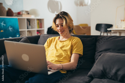 teenager using laptop computer at home