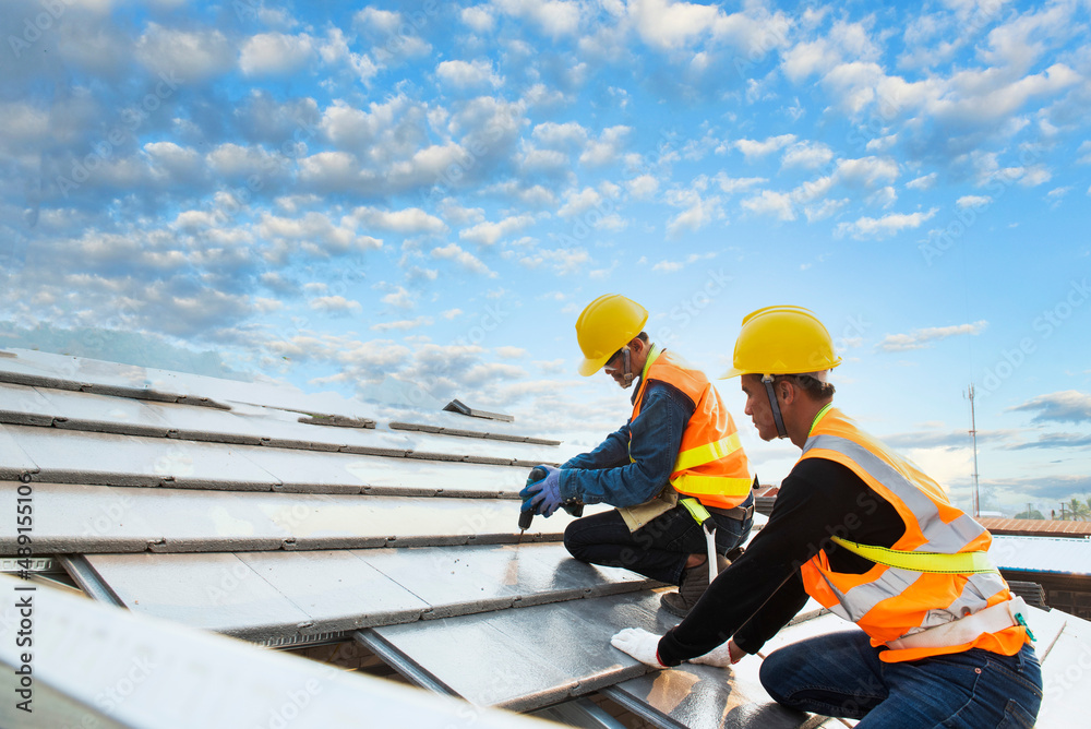 roof extension roof installation engineer roof-construction workers stand on tiled roof roof extension roof installation engineer roof-construction workers stand on tiled roof