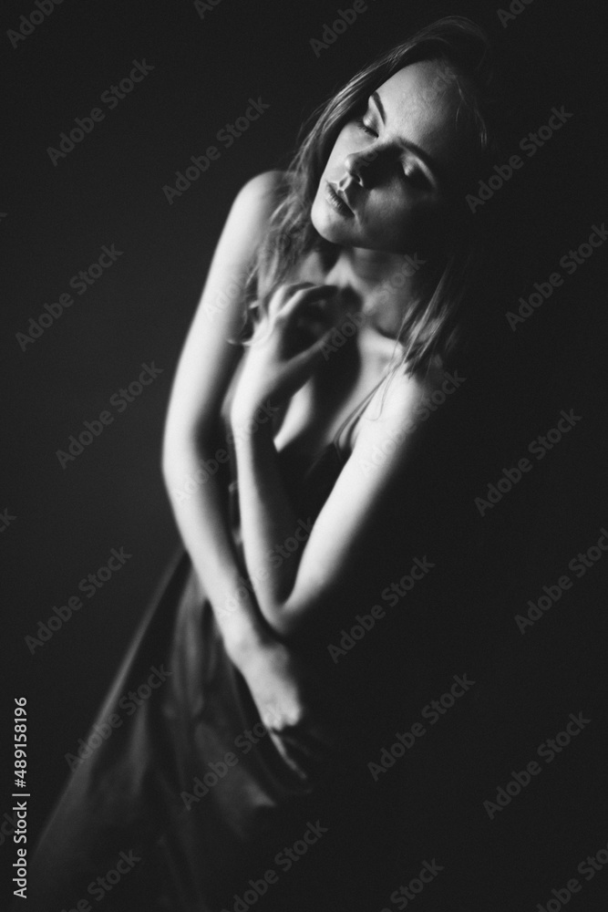 Art portrait of a girl in black and white. Light defocus and art noise on the frames Art portrait of a girl in black and white. Light defocus and art noise on the frames