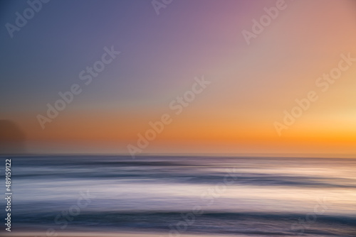 Orange glow panning sunrise seascape © Merrillie