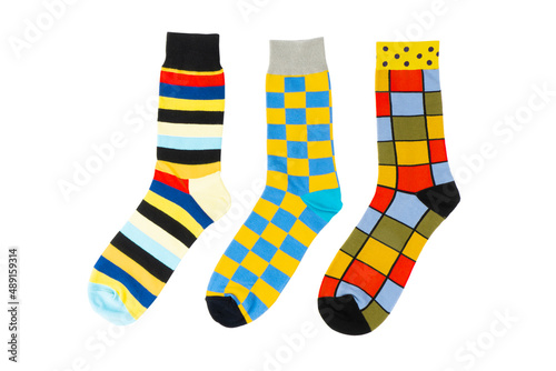 Three sock with different lines isolated on white background. Colorful sock son white background. Colored socks on the leg isolated on white background photo