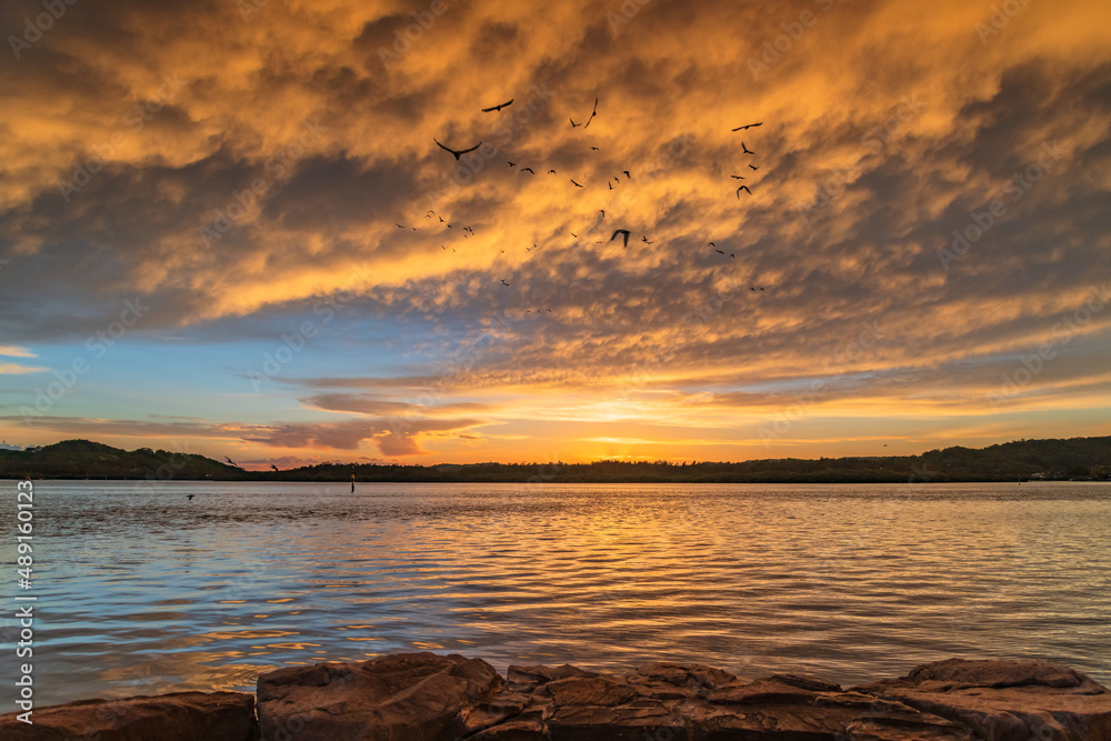 Sunrise by the bay with cumulonimbus clouds