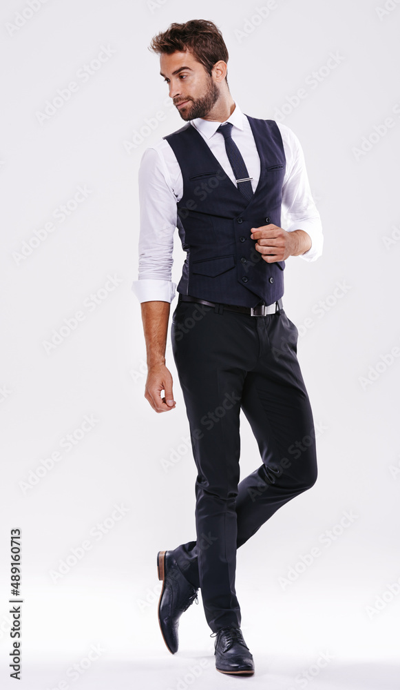 Handsome and successful. Studio shot of a well-dressed man against a gray background. Handsome and successful. Studio shot of a well-dressed man against a gray background.