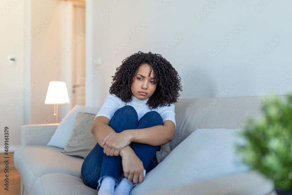 Young African American woman feeling upset, sad, unhappy or disappoint crying lonely in her room. Woman Suffering From Depression Sitting On Bed And Crying Young African American woman feeling upset, sad, unhappy or disappoint crying lonely in her room. Woman Suffering From Depression Sitting On Bed And Crying