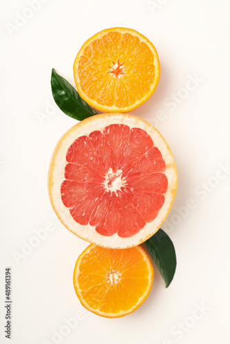 Citrus fruits with leaves on white background  top view