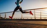 Fitness woman runner running on seaside bridge