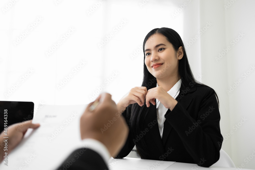 Business woman to greet a HR staff before a job interview to apply for a job. Happy woman seeker or insurance broker presenting a business deal. Smart asian woman sending resume. Business woman to greet a HR staff before a job interview to apply for a job. Happy woman seeker or insurance broker presenting a business deal. Smart asian woman sending resume.