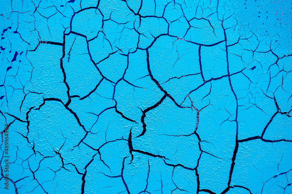 Cracked and damaged painted surface of a building or wall. Texture, aged paint background Cracked and damaged painted surface of a building or wall. Texture, aged paint background