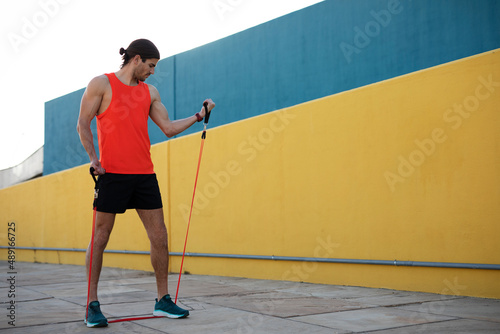 Young sexy man training outside. Fit handsome man doing exercise