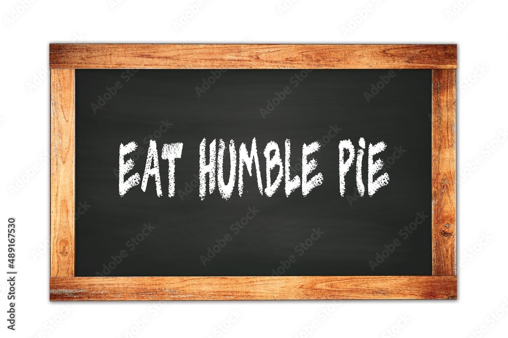EAT HUMBLE PIE text written on wooden frame school blackboard. EAT HUMBLE PIE text written on wooden frame school blackboard.