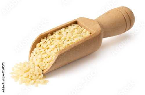 Hulled hemp seeds in the wooden scoop, isolated on the white background.