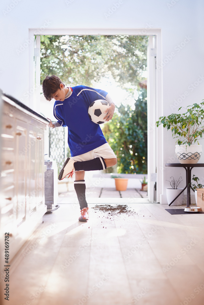 A ball is all he needs. Shot of a young boy holding a soccer ball. A ball is all he needs. Shot of a young boy holding a soccer ball.