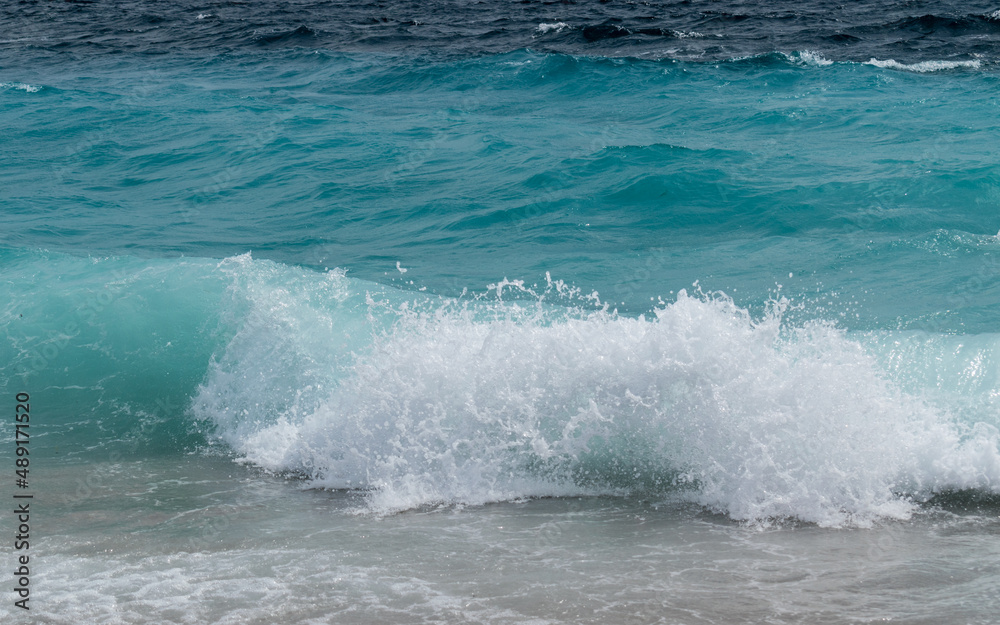 Wavy sea on the beach Zlatni rat near Bol town on the island of Brac in Croatia
