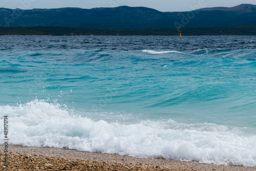 Fototapeta Naklejka Na Ścianę i Meble -  Wavy sea on the beach Zlatni rat near Bol town on the island of Brac in Croatia