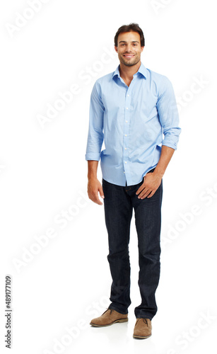 Handsome and charming. Handsome young guy standing casually against a white background.