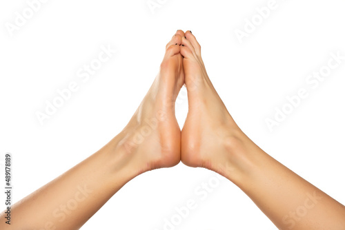 Beautiful woman's bare feet against a white background